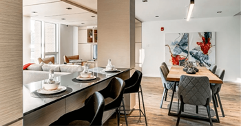 A modern dining room with a long table